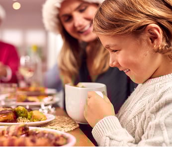 Young girl drinking hot chocolate mobile image